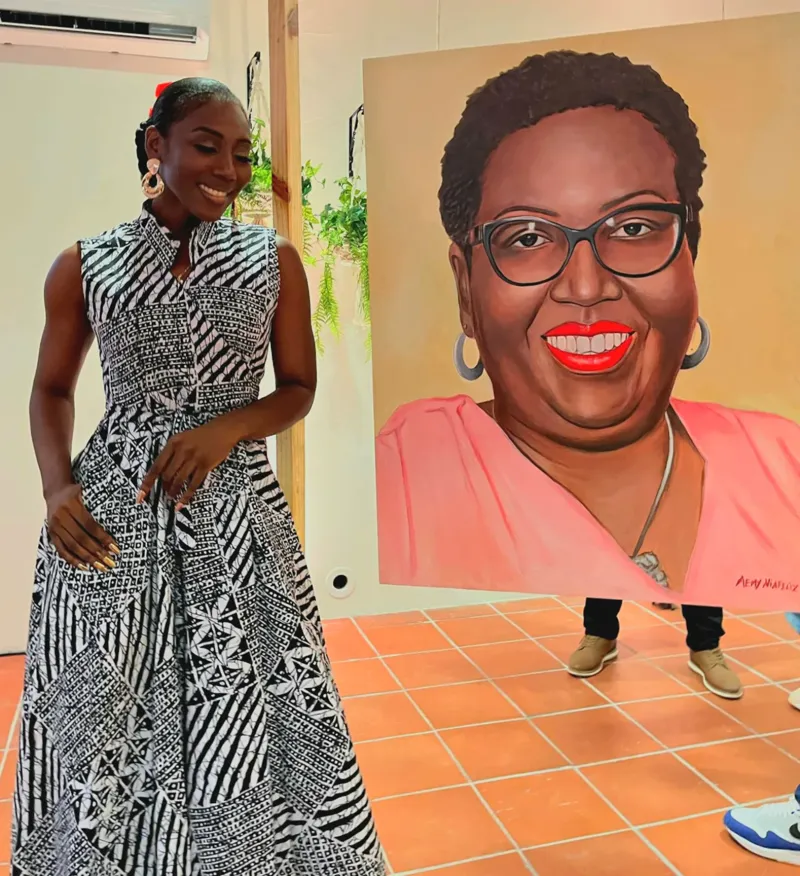 A woman beside her own portrait