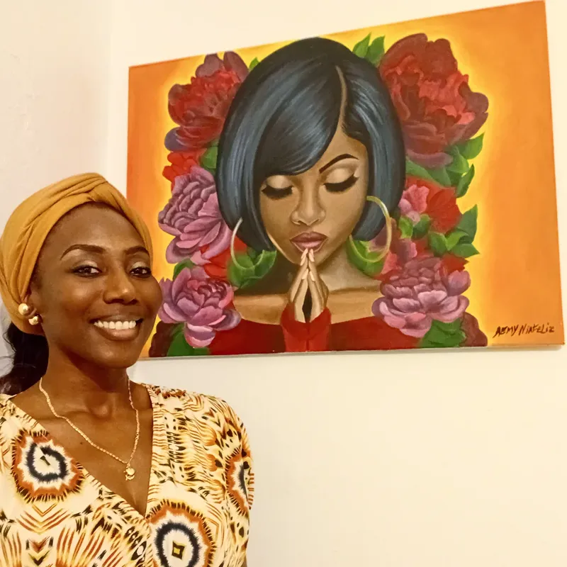 A woman holding the praying-woman canvas
