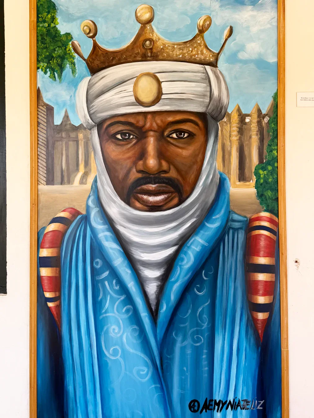 Painting of a crowned man in a blue and white robe