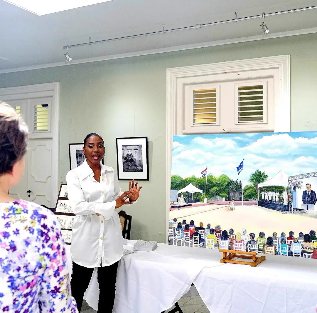 Æmy presenting the finished ceremony painting indoors