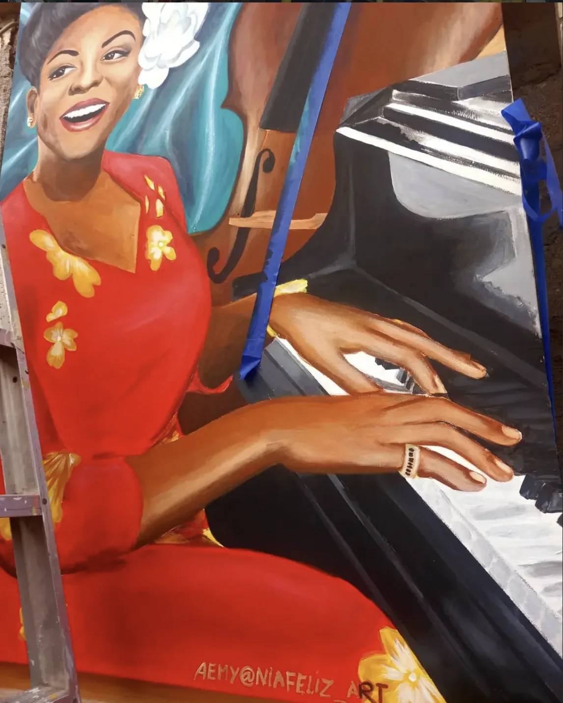 Painting of a woman in a red dress playing the piano
