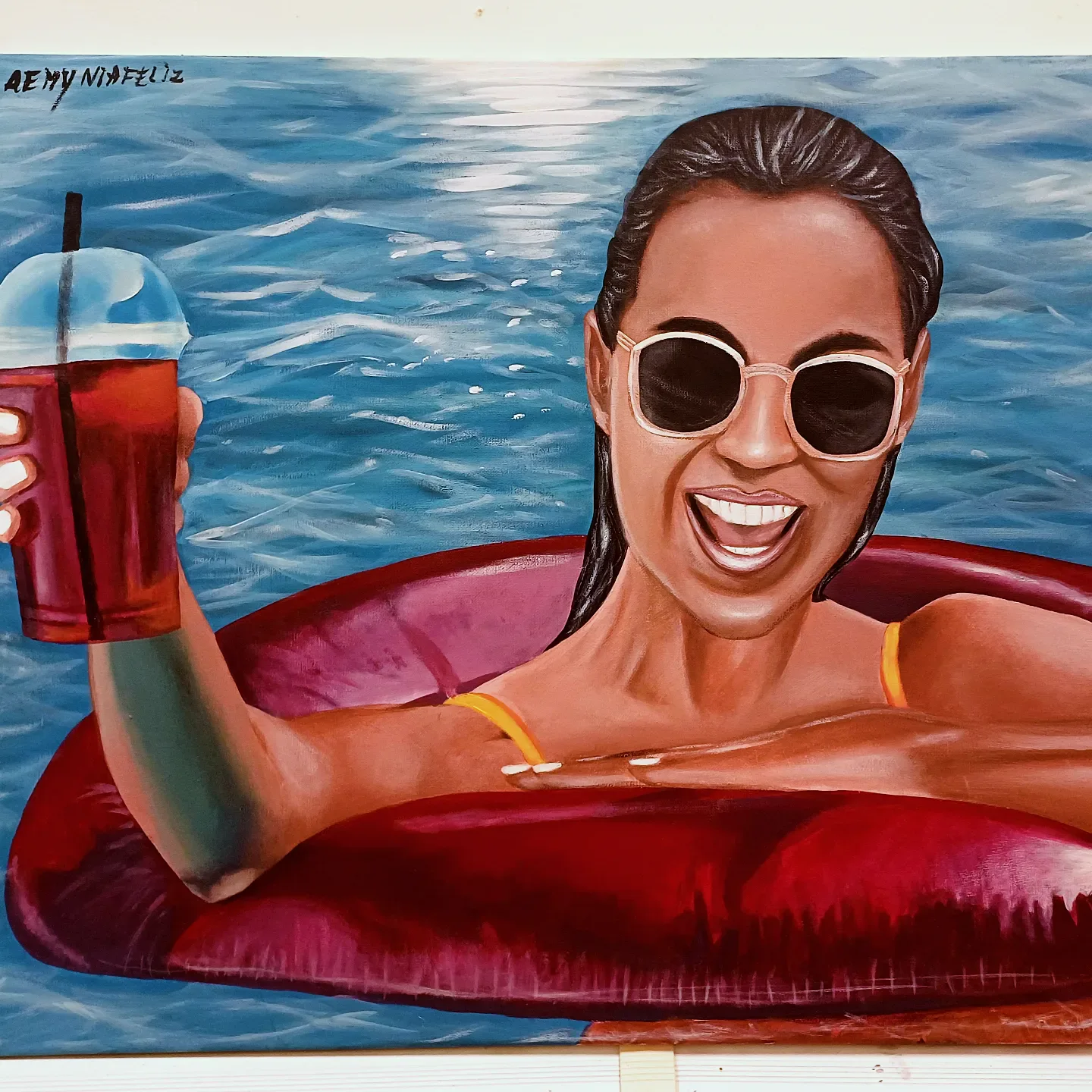 Painting of a laughing woman in sunglasses on a red pool float, holding a drink